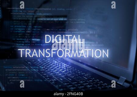 Digital transformation inscription against laptop and code background. Technology concept. Learn programming language. Stock Photo