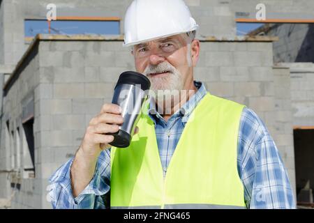 professional senior home builder engineer drinking hot coffee Stock Photo