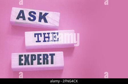 Ask the Expert words on wooden blocks. Consulting a professional, master or consultant for a solution and advice business concept. Stock Photo