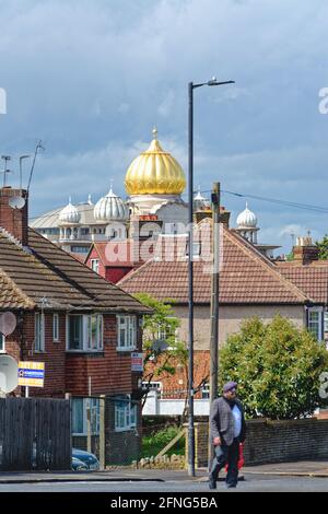 The golden dome of the Siri Guru Singh Sabha Gurdwara temple dominating the skyline in Southall London borough of Ealing England UK Stock Photo