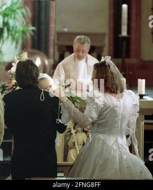 Germany / Family / Religion / 1996 Wedding party in Remagen Catholic Church. The couple comes with a baby, which will be baptized right after the wedding. // People / Mother / Child / Couple / Parents [automated translation] Stock Photo