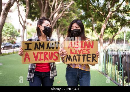 Anti Racism Mask Ethnic females in masks holding posters protesting against racism in ...