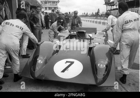1000 km race on the Nürburgring 01.06.1969. Ferrari 312P of Pedro Rodriguez and Chris Amon at the pit with mechanics in Shell - overalls. [automated translation] Stock Photo