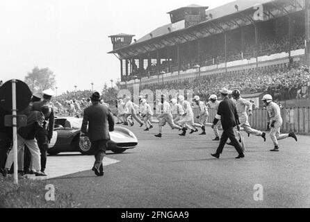 1000 km race at the Nürburgring 23.05.1965. Le Mans start. In the background the large grandstand [automated translation] Stock Photo