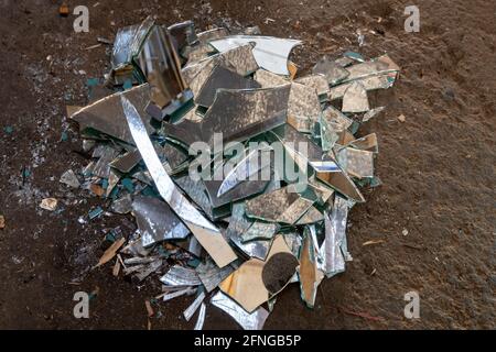 Broken mirror on stone floor Stock Photo