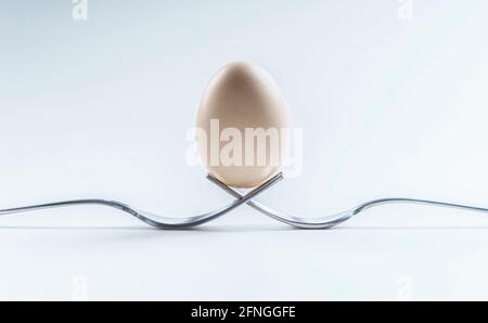 Egg on top of two forks Stock Photo