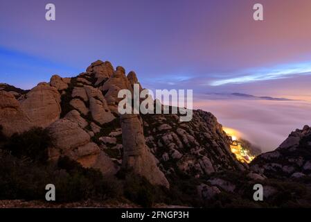 Montserrat spires and abbey at night, seen from the path up to Sant Jeroni (Barcelona, Catalonia, Spain) Stock Photo