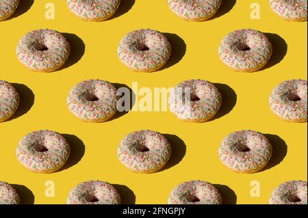 Donut pattern on yellow background. Sunlight minimal trendy concept Stock Photo