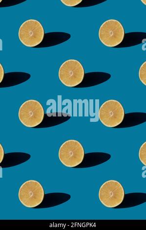 Grapefruit pattern on a blue background. Minimal concept with hard light shadows. Stock Photo