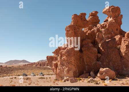 Three SUV 4x4 vehicles are parked in Bolivia's Atacama desert Stock Photo