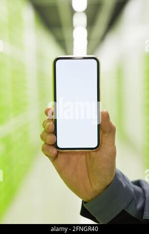 Close-up of man showing the screen of his smart phone Stock Photo