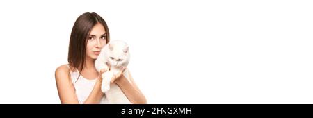 Young woman holding white cat. Allergy concept. Pretty human and pet Stock Photo