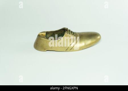 Golden color brass shoe ashtray used in antique piece to decorate the house Stock Photo