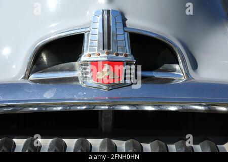 East Kurrajong, NSW, Australia - May 16, 2021. Close up of a vintage 1950s Holden Special (FJ) badge and part of the grill. Stock Photo