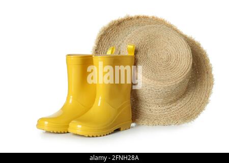 Rubber boots and straw hat isolated on white background Stock Photo