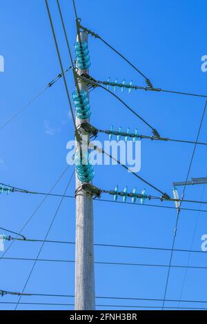 Power line pole with insulators Stock Photo