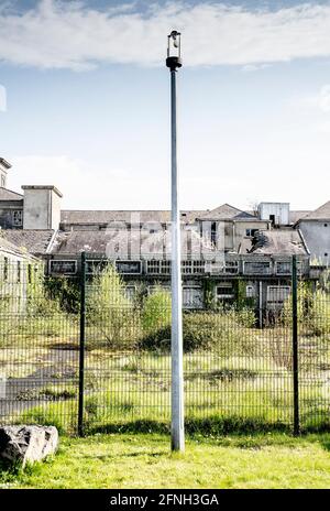 Exterior of abandoned brick buildings with overgrown fields Stock Photo ...