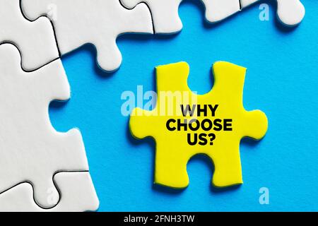 Why choose us message written on a puzzle piece. The reason or benefit to choose a certain service or product. Stock Photo