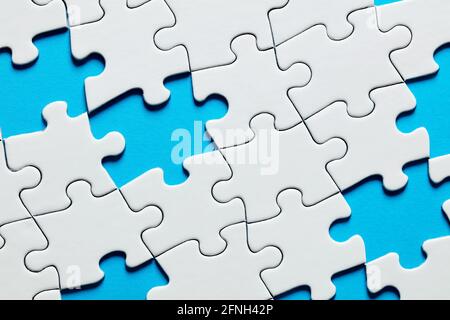 Missing puzzle pieces with blue background. Stock Photo
