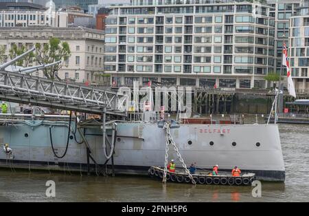 River Thames, London, UK. 17 May 2021. The cruiser HMS Belfast receives some much needed t.l.c as it is primed and repainted before its reopening in July 2021. Credit: Malcolm Park/Alamy Live News. Stock Photo