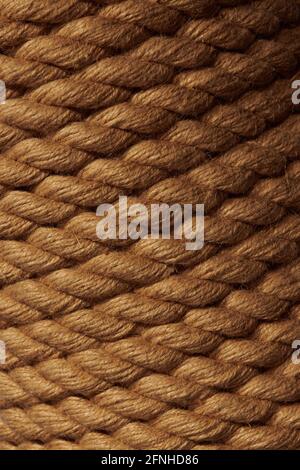 Closeup rope background. Low light brown rope texture. Vertical gradient pattern. Stock Photo