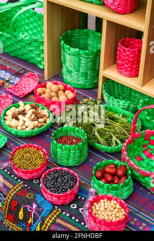 Zhuang brocade and bamboo woven baskets with characteristics of Guangxi Zhuang nationality, containing miscellaneous grains Stock Photo