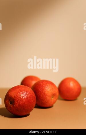 Juicy dark tangerines on light background. Tasty fruits. Focus on front tangerine. Stock Photo