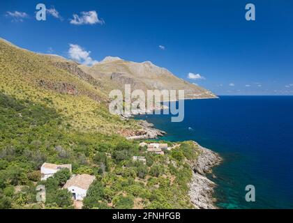 Zingaro Nature Reserve, Trapani, Sicily, Italy. View over coastline of the Gulf of Castellammare from Punta Leone, rural houses clinging to hillside. Stock Photo