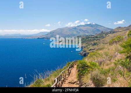 Zingaro Nature Reserve, Trapani, Sicily, Italy. View from sandy track across the Gulf of Castellammare to Scopello and distant Monte Inici. Stock Photo