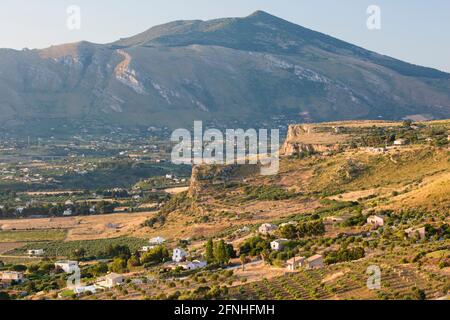 Scopello, Trapani, Sicily, Italy. View over typical agricultural landscape from the Torre Bennistra, sunrise, Monte Inici in background. Stock Photo