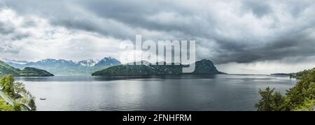 Aerial wide panorama. Storm over the Alps mountains and lake Lucerne. Storm clouds, rain front. Switzerland. Stock Photo