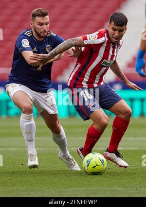 Angel Correa (Atletico de Madrid) and Lucas Torro (CA Osasuna) battle for the ball during the La Liga match round 36 between Atletico Madrid and CA Osasuna at Wanda Metropolitano Stadium.Sporting stadiums around Spain remain under strict restrictions due to the Coronavirus Pandemic as Government social distancing laws prohibit fans inside venues resulting in games being played behind closed doors. Final score; Atletico Madrid 2:1 CA Osasuna. Stock Photo