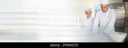 Two chefs cooking in a kitchen, restaurant kitchen and food industry concepts Stock Photo