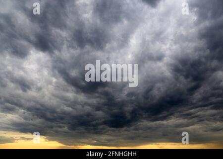 Sky covered with dark storm clouds. Dramatic background for weather before rain Stock Photo