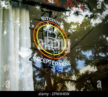 Bitcoin accepted here is displayed in the window of a store in the East Village in New York on Saturday, May 15, 2021.  (ÂPhoto by Richard B. Levine) Stock Photo