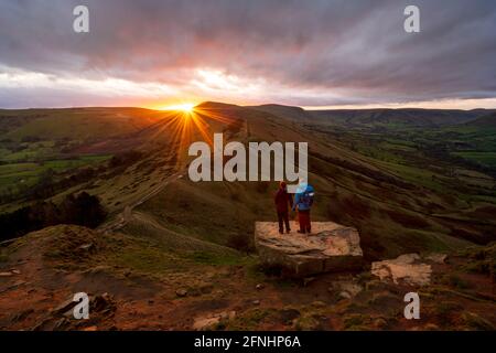 A couple stood looking towards Mam Tor from The Great Ridge, Peak District, Derbyshire Stock Photo