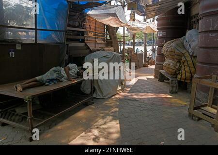 Kolkata, India. 17th May, 2021. A man taking rest on footpath during ongoing Covid-induced lockdown in Kolkata. (Photo by Suraranjan Nandi/Pacific Press) Credit: Pacific Press Media Production Corp./Alamy Live News Stock Photo