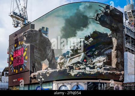 London, UK. 17th May, 2021. On the day Cinemas are allowed to re-open, a 3-D live action billboard, Piccadilly Lights, to launch Zack Snyder's (Justice League) forthcoming blockbuster movie ARMY OF THE DEAD. Using the entirety of the curved digital screen in Piccadilly Circus, the activation introduces Londoners to “Valentine”, the zombie tiger which appears in the film. The VFX tiger, created by visual effects supervisor Marcus Taormina (Bird Box, Guardians Of The Galaxy) roaming around post-apocalyptic Las Vegas. Credit: Guy Bell/Alamy Live News Stock Photo