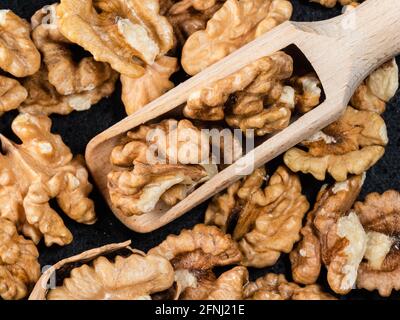 top view of wooden scoop on peeled walnuts close up Stock Photo