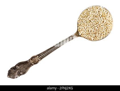 top view of quinoa seeds in tablespoon cutout on white background Stock Photo