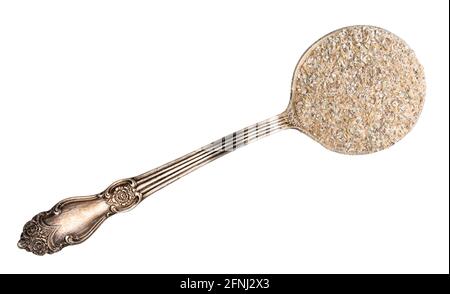 top view of rye bran in silver tablespoon cutout on white background Stock Photo