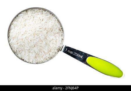 top view of raw long-grain polished rice in measuring cup cutout on white background