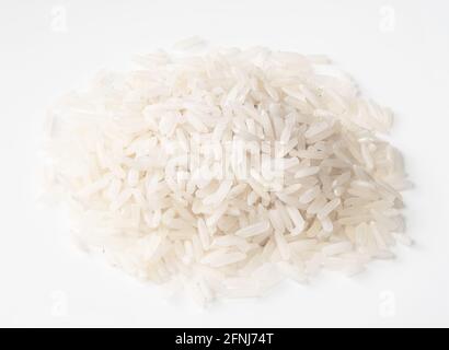 handful of raw long-grain polished rice closeup on white background