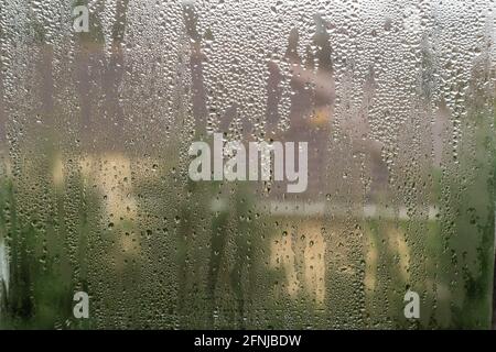 Closeup to condensation on the glass on a window. A common problem when window are not double glazed. Stock Photo