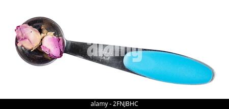 top view of dried rose buds in measuring teaspoon cutout on white background Stock Photo