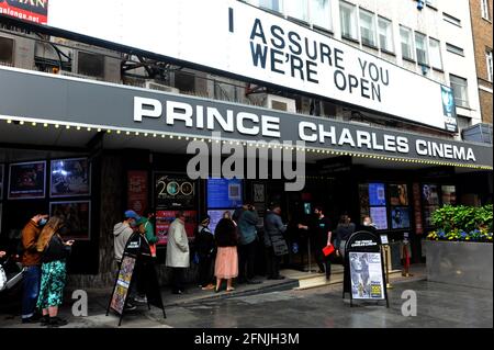 London, UK, 17 May 2021 Customers queue in Soho on the first day of opening of cinemas after lockdown. Heavy rain dampens first day of lockdown freedom in West End. Credit: JOHNNY ARMSTEAD/Alamy Live News Stock Photo