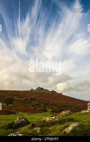 High cirrus clouds appear over Hound Tor on Dartmoor, England. Stock Photo
