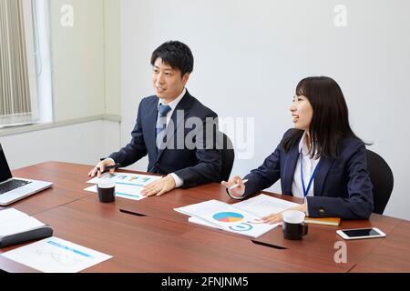 Japanese businesspeople working in the office Stock Photo