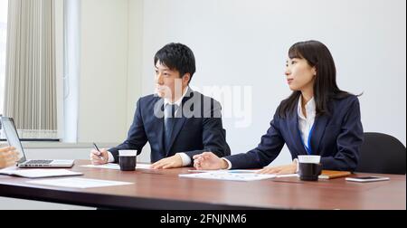 Japanese businesspeople working in the office Stock Photo