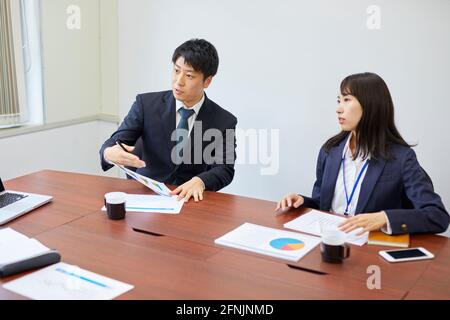 Japanese businesspeople working in the office Stock Photo